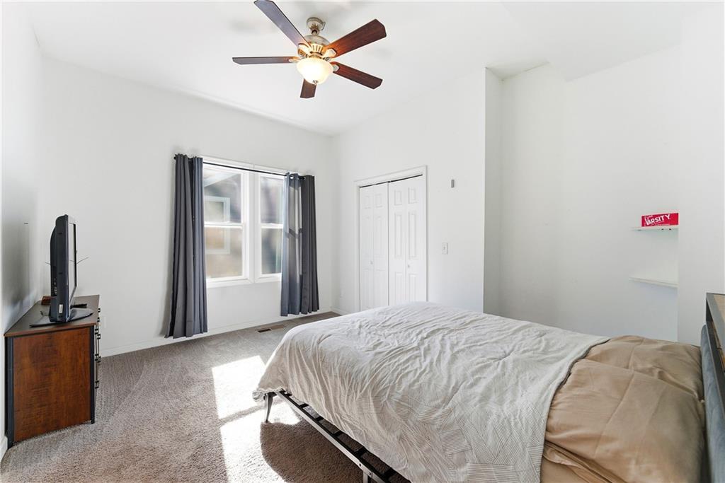 902 Gaston Street Southwest Atlanta, GA 30310 - Photo 16 of 36 a bedroom with a bed and a flat screen tv