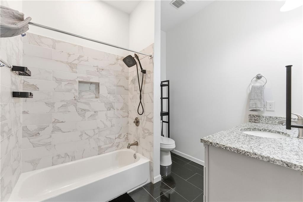 902 Gaston Street Southwest Atlanta, GA 30310 - Photo 18 of 36 a bathroom with a granite countertop bathtub shower sink and toilet