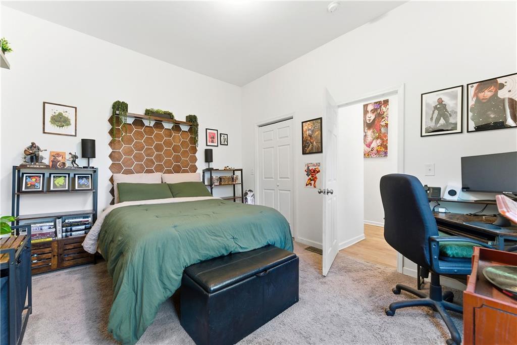 902 Gaston Street Southwest Atlanta, GA 30310 - Photo 22 of 36 a bedroom with a bed a computer on a desk and chair