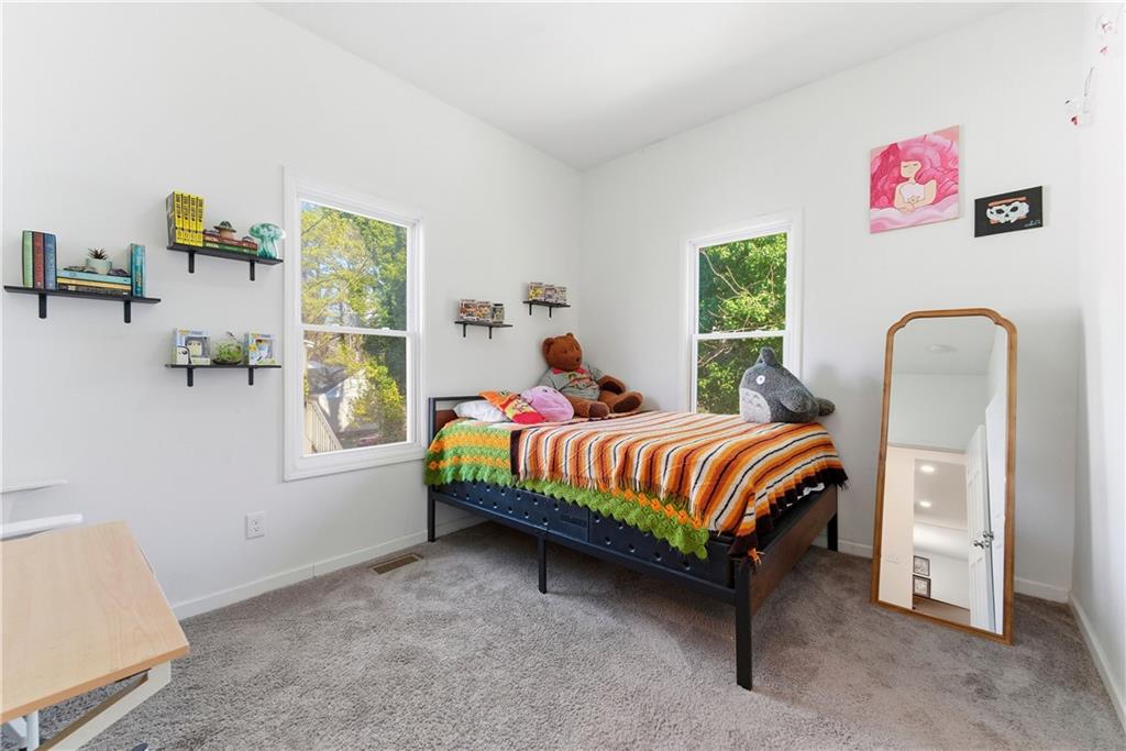 902 Gaston Street Southwest Atlanta, GA 30310 - Photo 23 of 36 a bedroom with a bed and a window