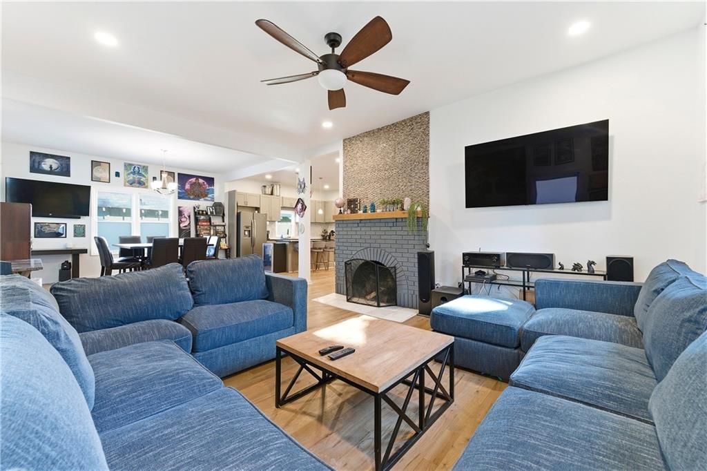 902 Gaston Street Southwest Atlanta, GA 30310 - Photo 8 of 36 a living room with furniture a fireplace and a flat screen tv