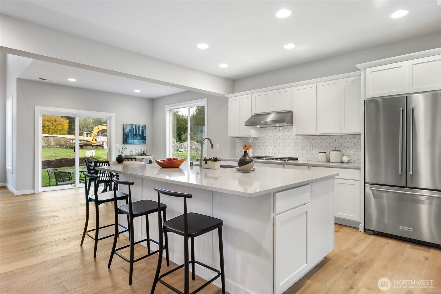 9801 Kelly Road Northeast Carnation, WA 98014 - Photo 10 of 34 a kitchen with stainless steel appliances granite countertop a sink a stove a refrigerator and island with wooden floor