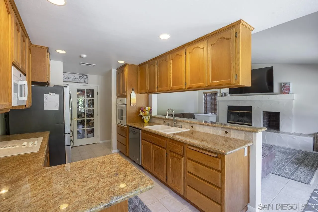 1603 Camino Del Sequan Alpine, CA 91901 - Photo 26 of 48 a kitchen with a stove a sink and a microwave