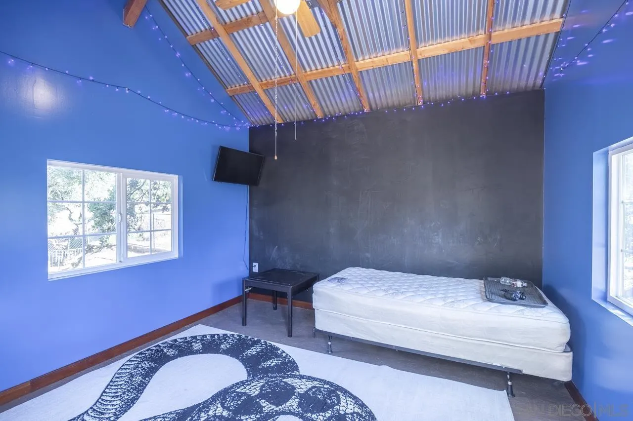 1603 Camino Del Sequan Alpine, CA 91901 - Photo 38 of 48 a bedroom with a bed and a chandelier