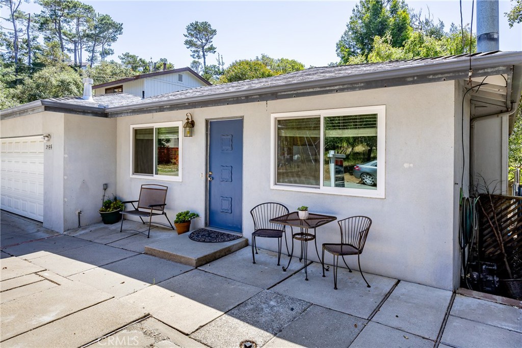 2155 Cowper Street Cambria, CA 93428 - Photo 2 of 35 a backyard of a house with table and chairs