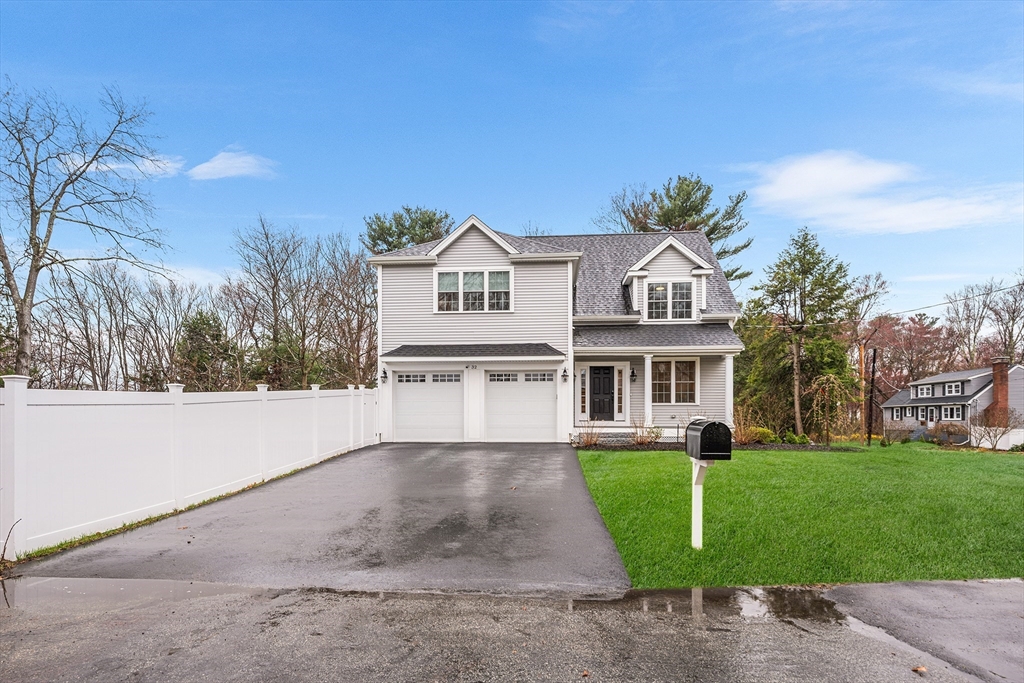 a front view of house with yard and green space