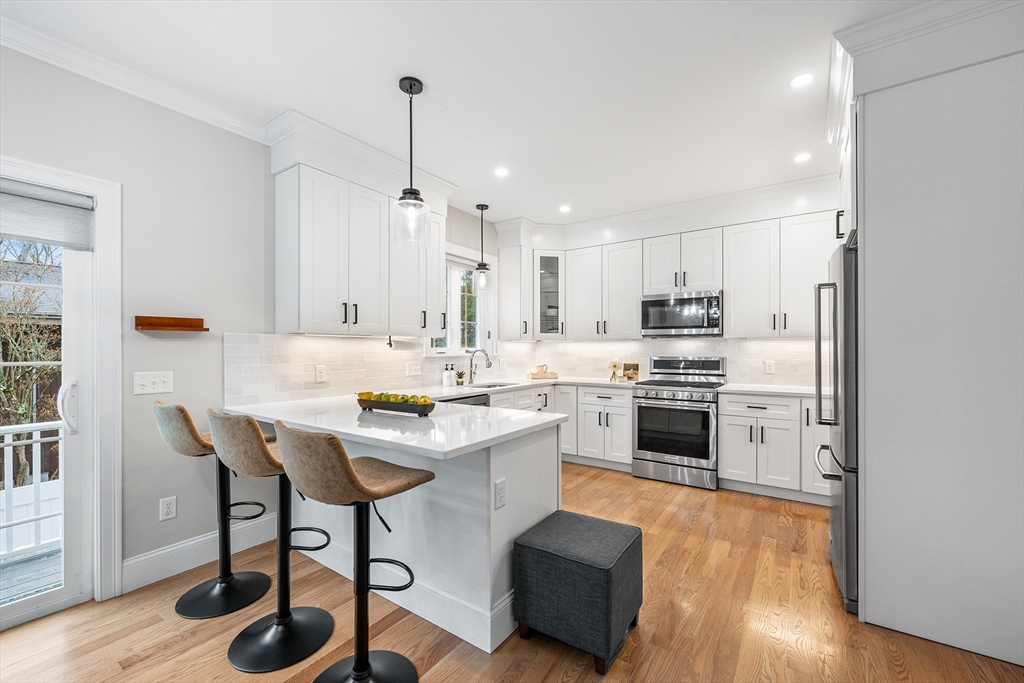 32 Fraser Road Framingham, MA 01702 - Photo 11 of 37 a kitchen with a white cabinets and chairs