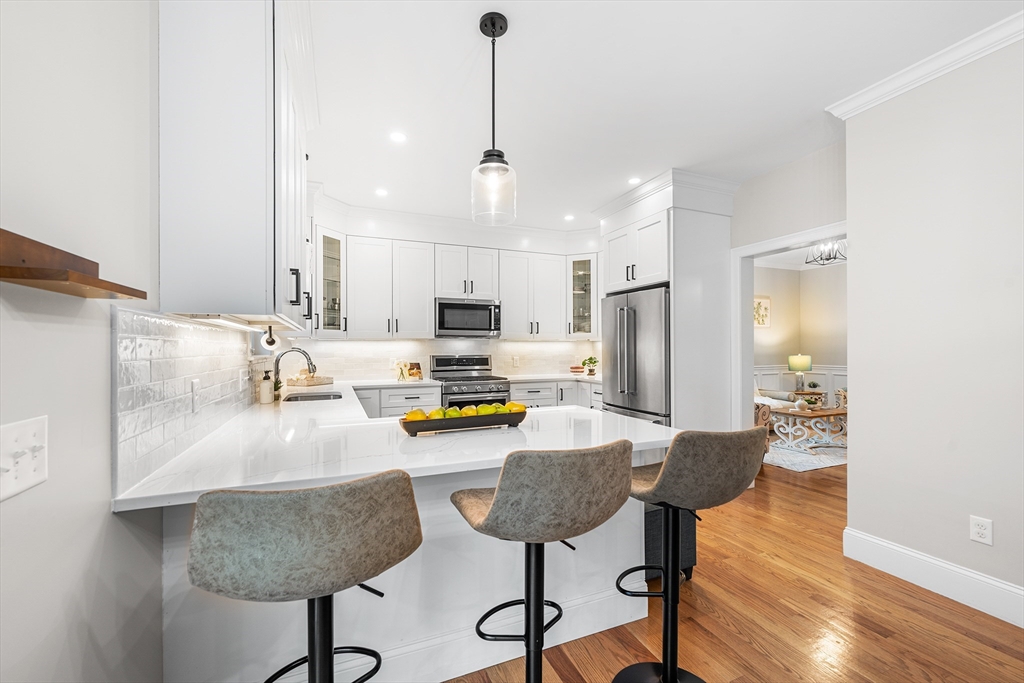 32 Fraser Road Framingham, MA 01702 - Photo 12 of 37 a kitchen with refrigerator and chairs