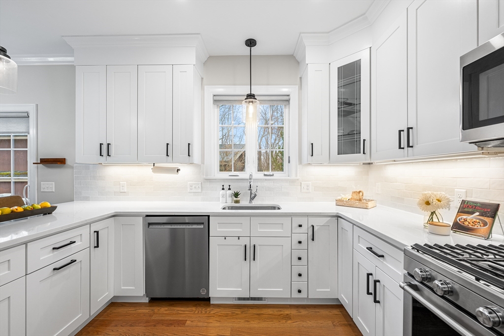 32 Fraser Road Framingham, MA 01702 - Photo 14 of 37 a kitchen with a sink stove and cabinets