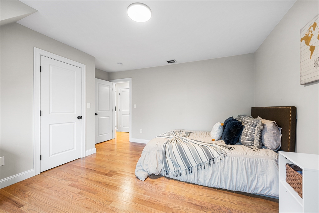 32 Fraser Road Framingham, MA 01702 - Photo 21 of 37 a bedroom with a bed and a wooden floor