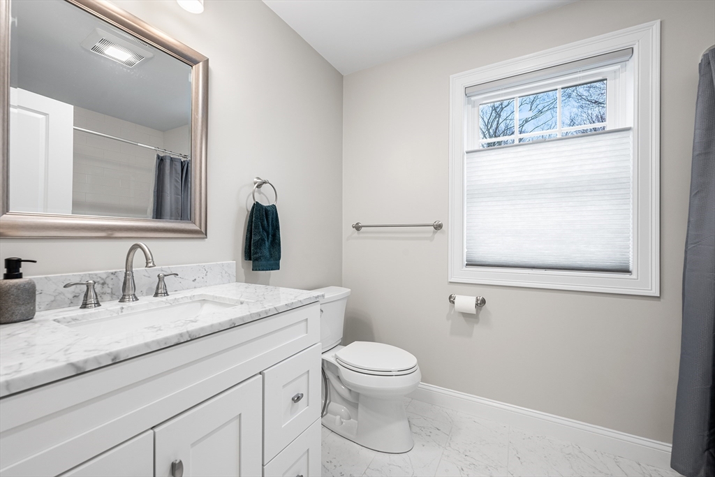 32 Fraser Road Framingham, MA 01702 - Photo 36 of 37 a bathroom with a granite countertop sink mirror vanity and toilet