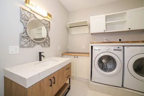 a utility room with sink dryer and washer