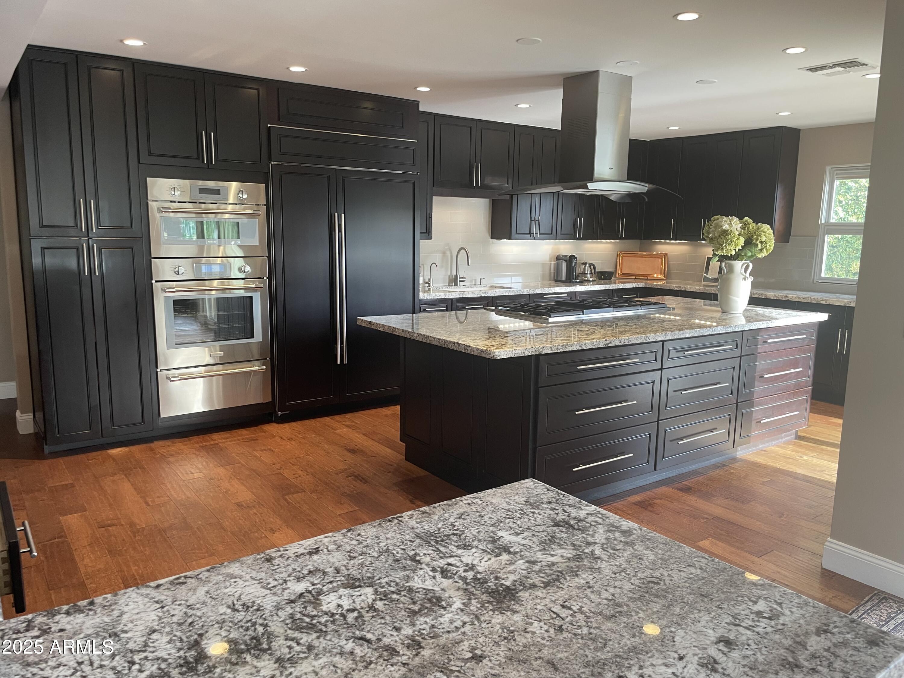 3103 East Georgia Avenue Phoenix, AZ 85016 - Photo 12 of 36 a kitchen with stainless steel appliances kitchen island granite countertop a stove and a refrigerator