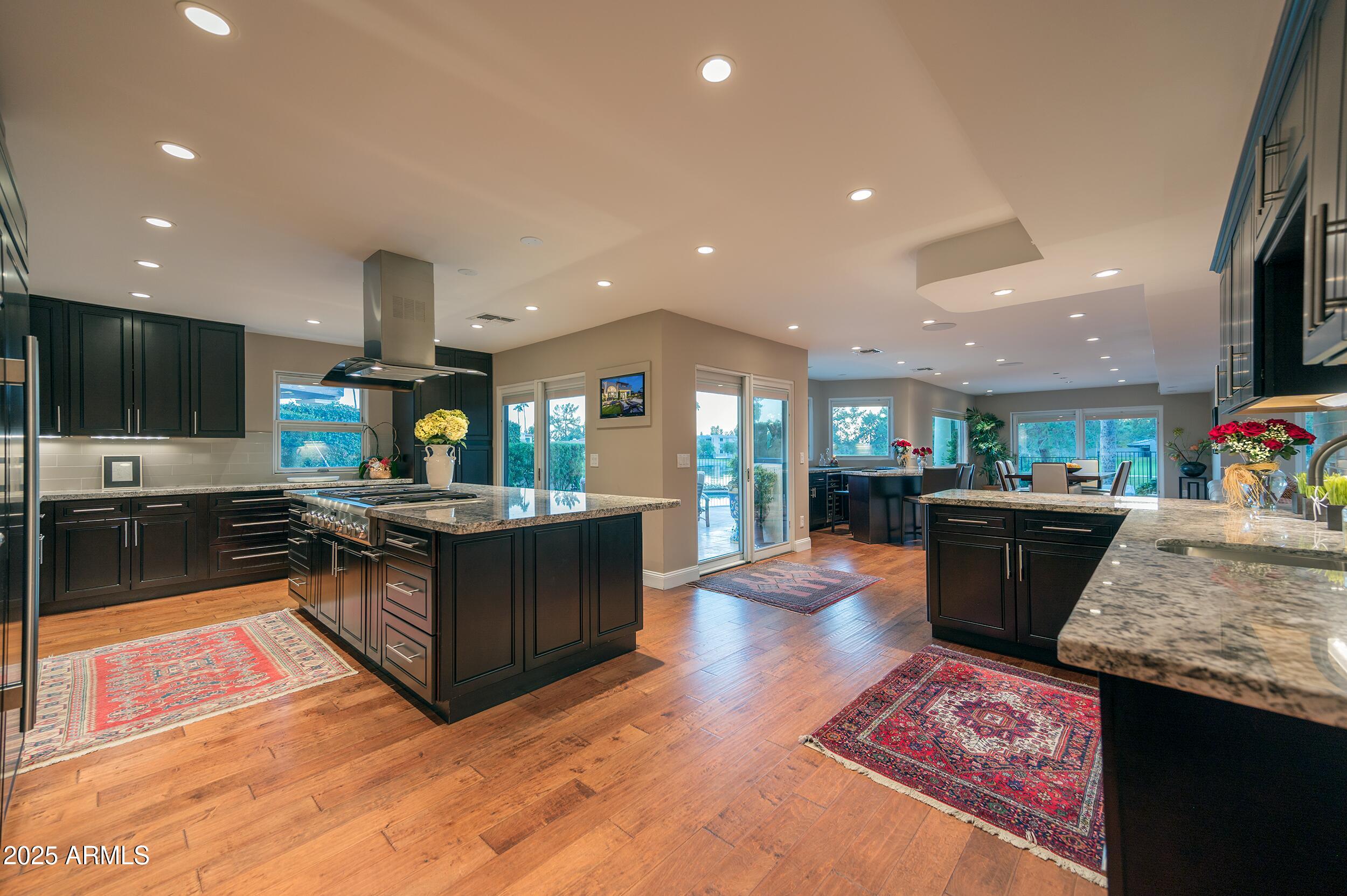 3103 East Georgia Avenue Phoenix, AZ 85016 - Photo 14 of 36 a living room with stainless steel appliances kitchen island granite countertop a couch and a flat screen tv