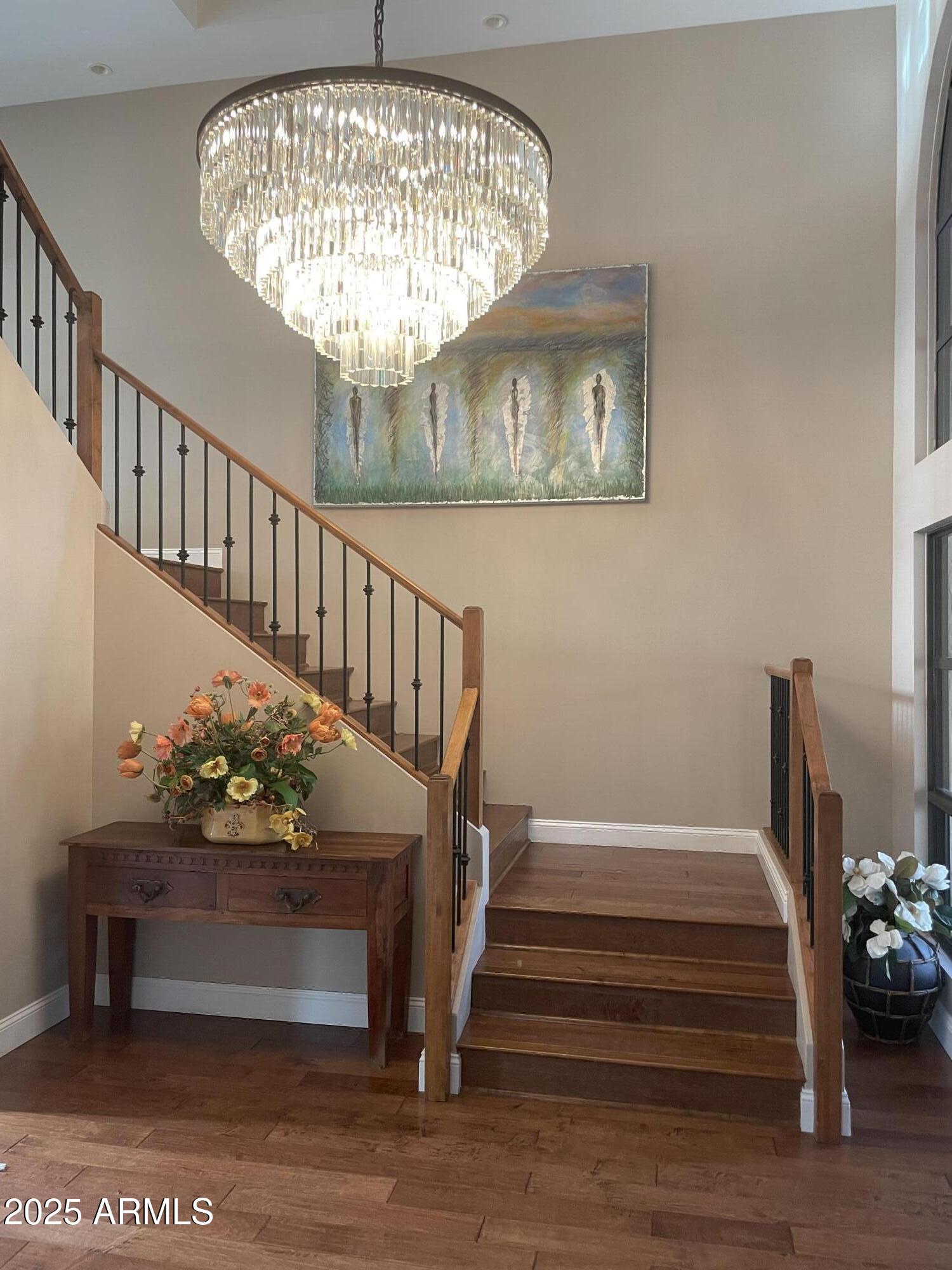 3103 East Georgia Avenue Phoenix, AZ 85016 - Photo 5 of 36 a view of staircase with wooden floor and a chandelier