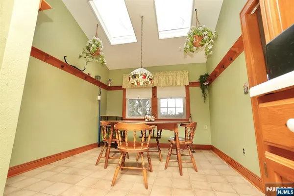 a view of a dining room with furniture and a chandelier