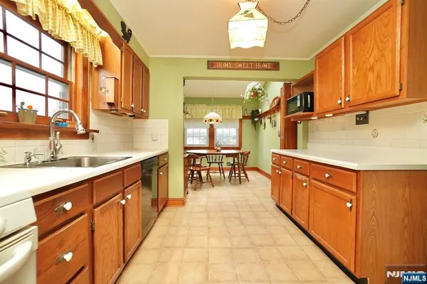 a large kitchen with stainless steel appliances granite countertop a sink and cabinets