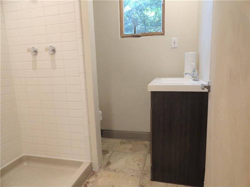 112 Saunders Road Trafford, PA 15085 - Photo 11 of 23 The smaller master suite is located off the kitchen area. Here shown is accompanying bath (the second of three). This could be Alices private quarters should you have a live-in housekeeper.