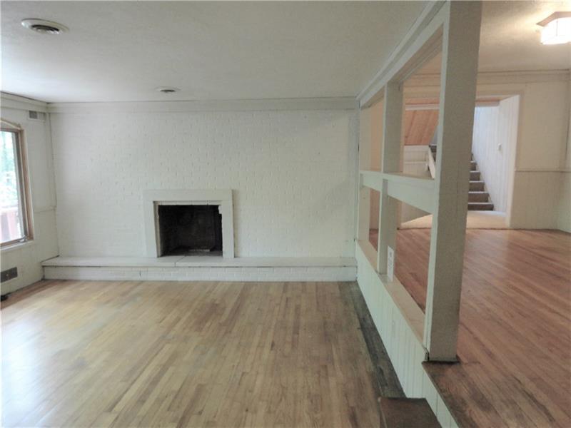 112 Saunders Road Trafford, PA 15085 - Photo 12 of 23 The entire first floor is two-tiered with the front side a step or two lower than the rear side. The fireplace shown is for log burning.