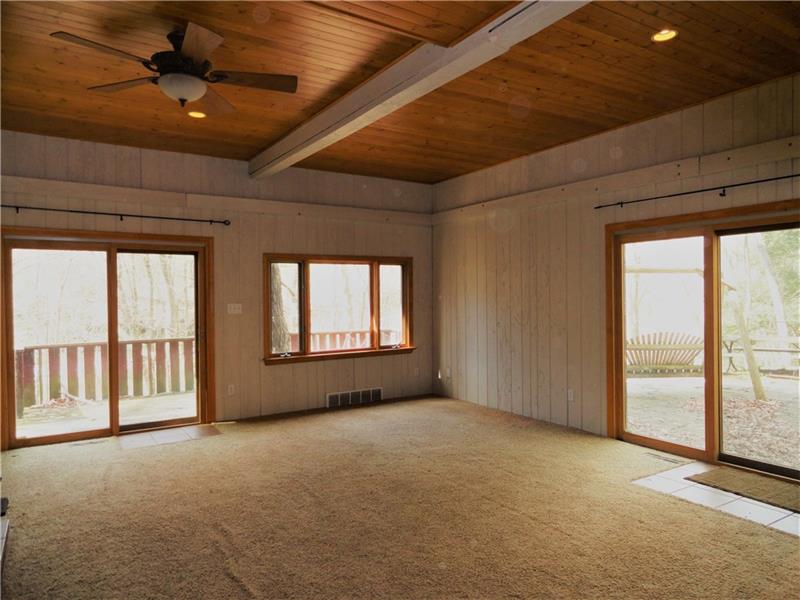112 Saunders Road Trafford, PA 15085 - Photo 15 of 23 Youll love your life in the family room which is also sunken in the added section. The outside deck wraps around from the front to the side. The wood burning stove (not shown but just off to the left of the picture) is included.