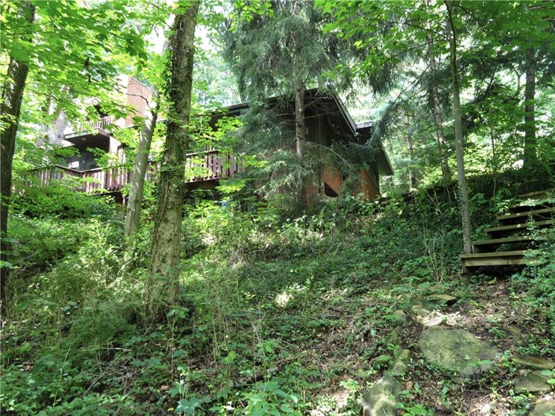 112 Saunders Road Trafford, PA 15085 - Photo 23 of 23 The stone-lined trail meets the wooden stair to the main residence driveway. Your possibilities are endless here.