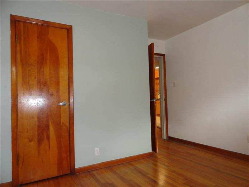 This photo represents all three of the original home bedrooms  note the  tongue and groove hardwood flooring.