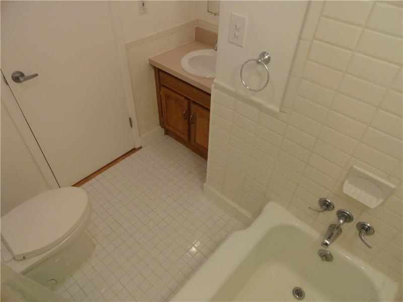 This, the first of three full baths, is in proximity to the three original home bedrooms.