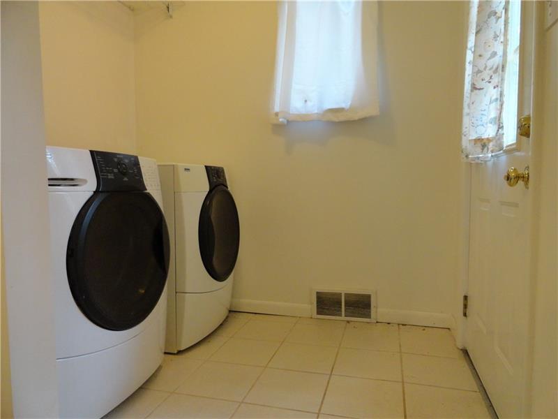 112 Saunders Road Trafford, PA 15085 - Photo 10 of 23 The laundry/mudroom is accessed from the kitchen. The laundry equipment is included.