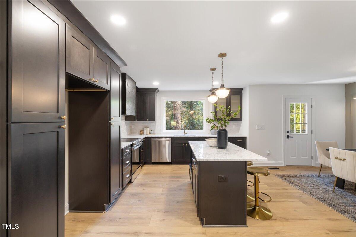 2703 Augusta Drive Durham, NC 27707 - Photo 11 of 45 a kitchen with stainless steel appliances granite countertop a refrigerator and a sink