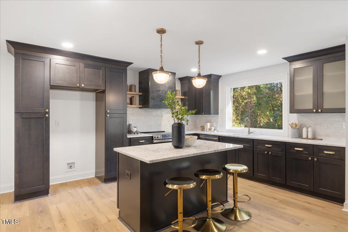 2703 Augusta Drive Durham, NC 27707 - Photo 12 of 45 a kitchen with a sink a counter space appliances and cabinets