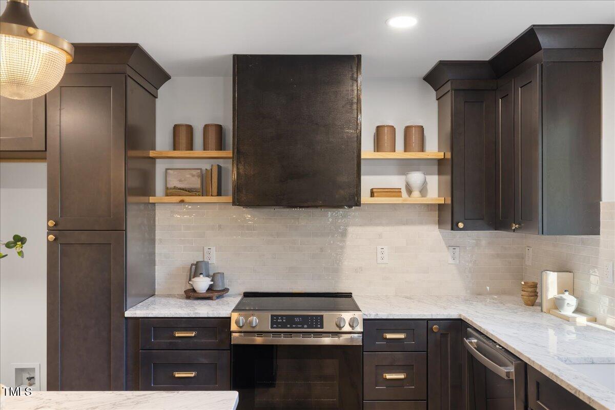 2703 Augusta Drive Durham, NC 27707 - Photo 14 of 45 a kitchen with stainless steel appliances a sink stove and cabinets