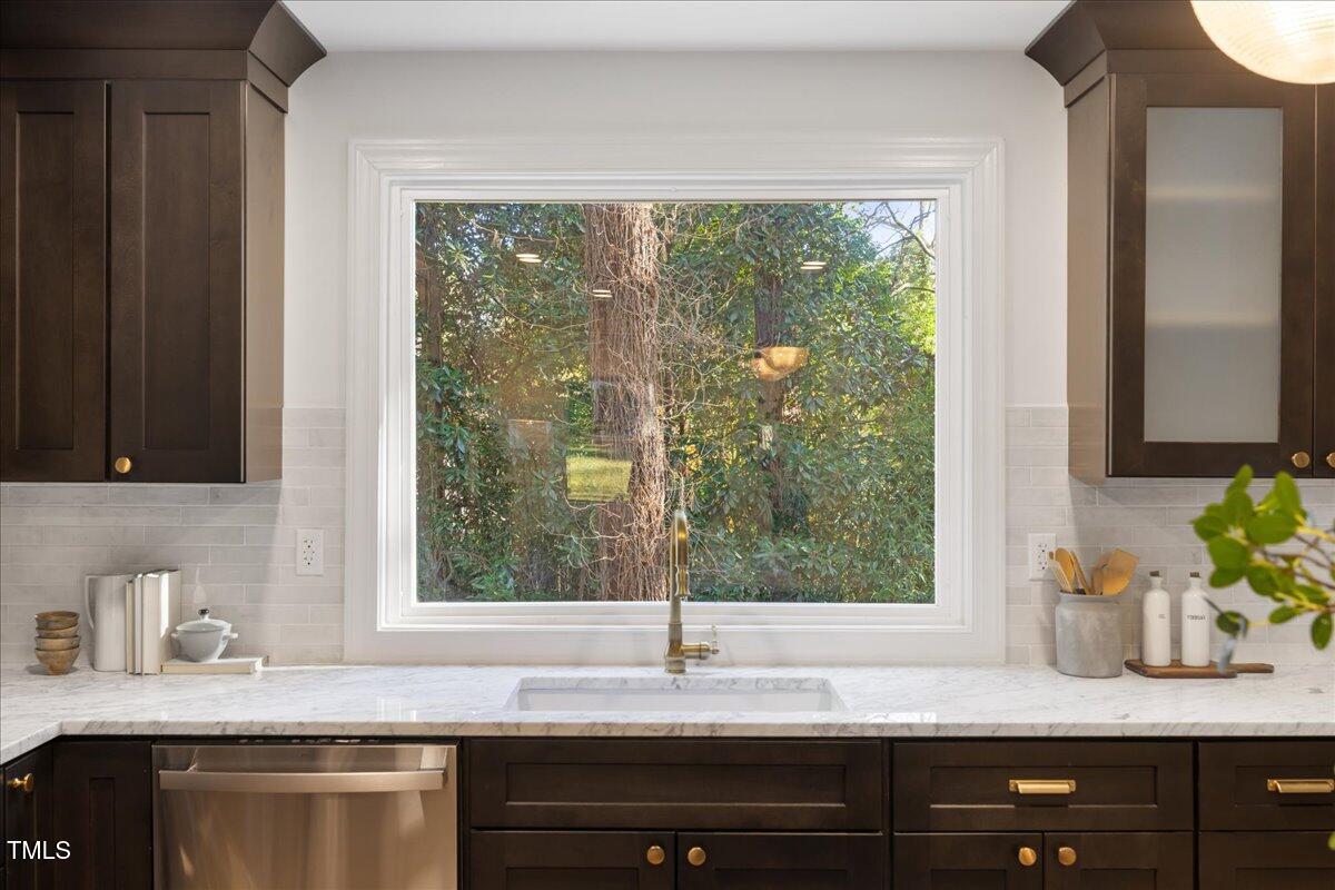 2703 Augusta Drive Durham, NC 27707 - Photo 15 of 45 a kitchen with granite countertop a sink window and cabinets