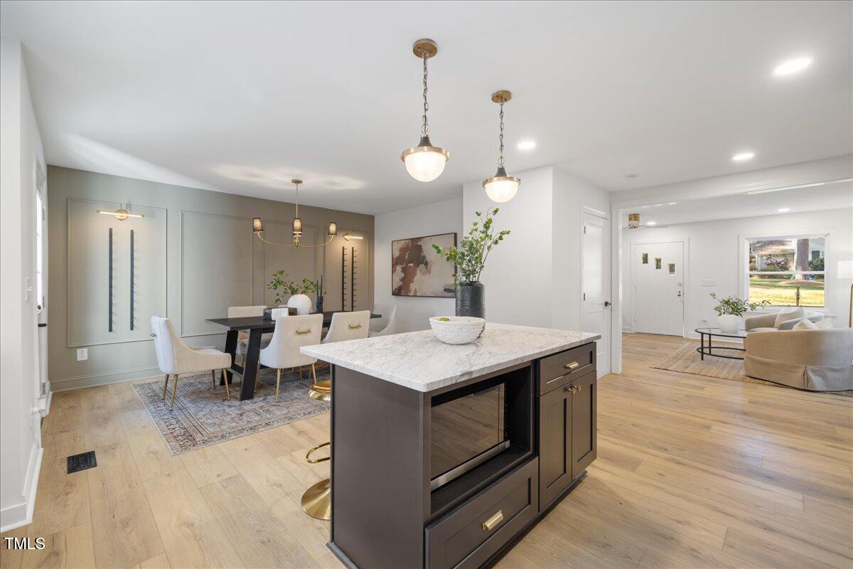 2703 Augusta Drive Durham, NC 27707 - Photo 16 of 45 a kitchen with stainless steel appliances granite countertop a stove a sink a oven and a dining table with wooden floor