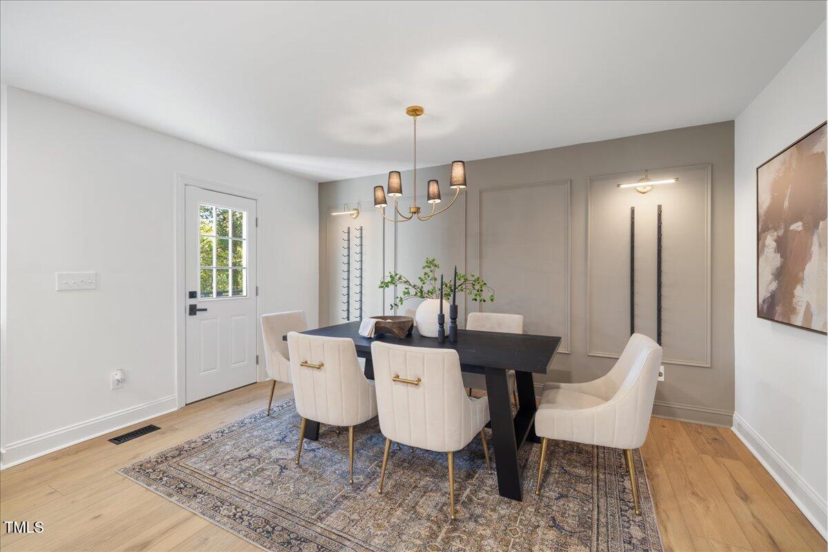 2703 Augusta Drive Durham, NC 27707 - Photo 17 of 45 a view of a dining room with furniture and wooden floor