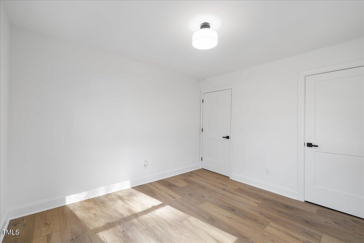 2703 Augusta Drive Durham, NC 27707 - Photo 21 of 45 a view of a room with wooden floor and white walls