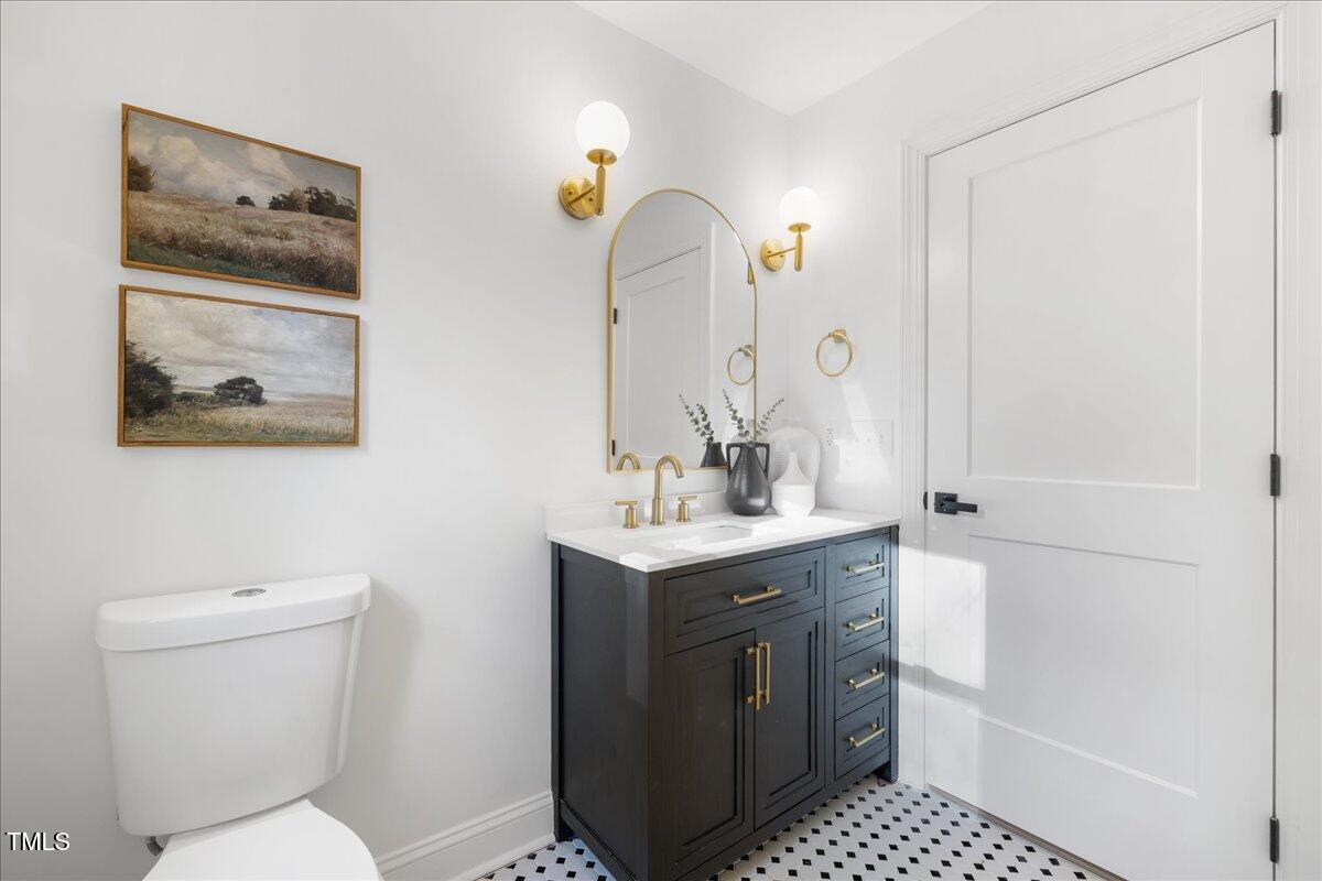 2703 Augusta Drive Durham, NC 27707 - Photo 23 of 45 a bathroom with a toilet a sink and a mirror