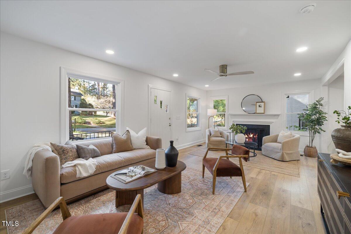2703 Augusta Drive Durham, NC 27707 - Photo 7 of 45 a living room with furniture a fireplace and wooden floor