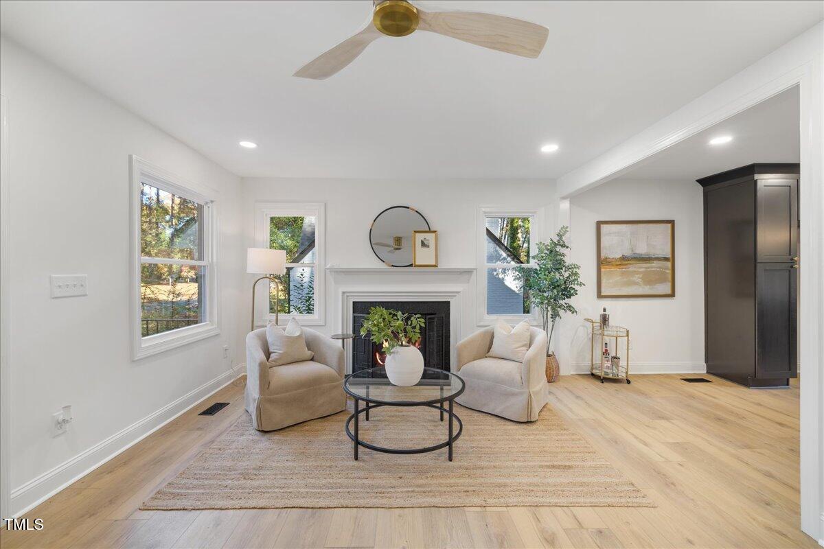 2703 Augusta Drive Durham, NC 27707 - Photo 8 of 45 a living room with furniture a fireplace and a table
