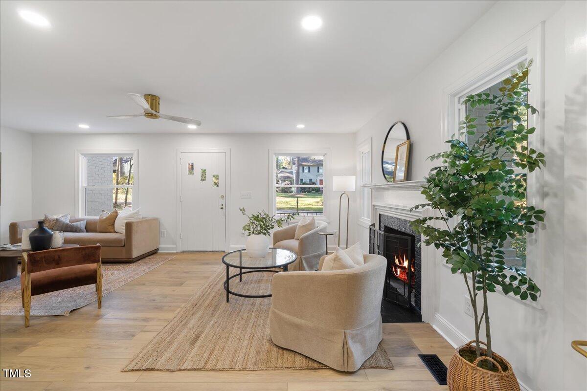 2703 Augusta Drive Durham, NC 27707 - Photo 9 of 45 a living room with furniture a potted plant and a fireplace