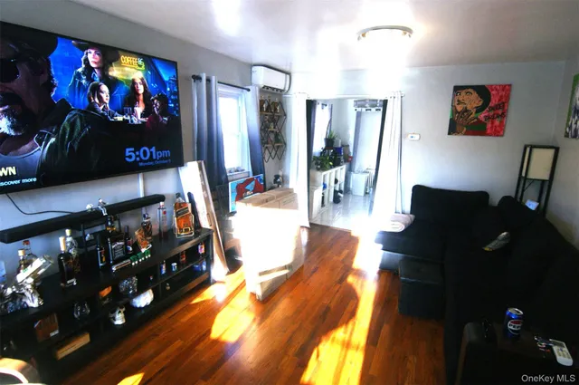 a view of a living room with furniture and a flat screen tv