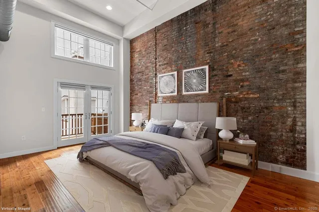 a bedroom with a bed couch and a window