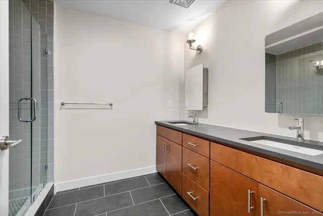 a bathroom with a double vanity sink and mirror