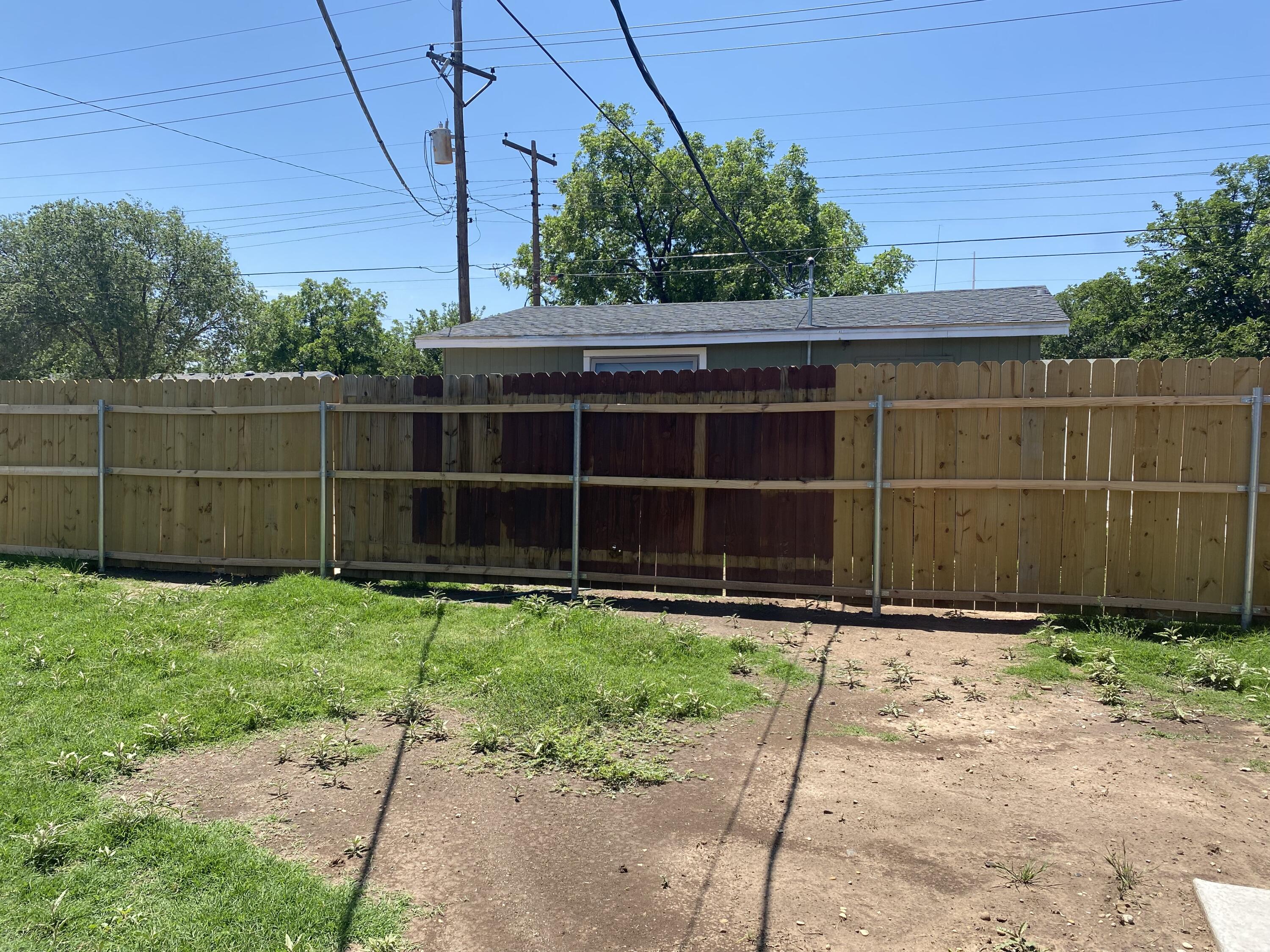 4101 32nd Street Lubbock, TX 79410 - Photo 13 of 13 a view of a backyard with potted plants and a small yard