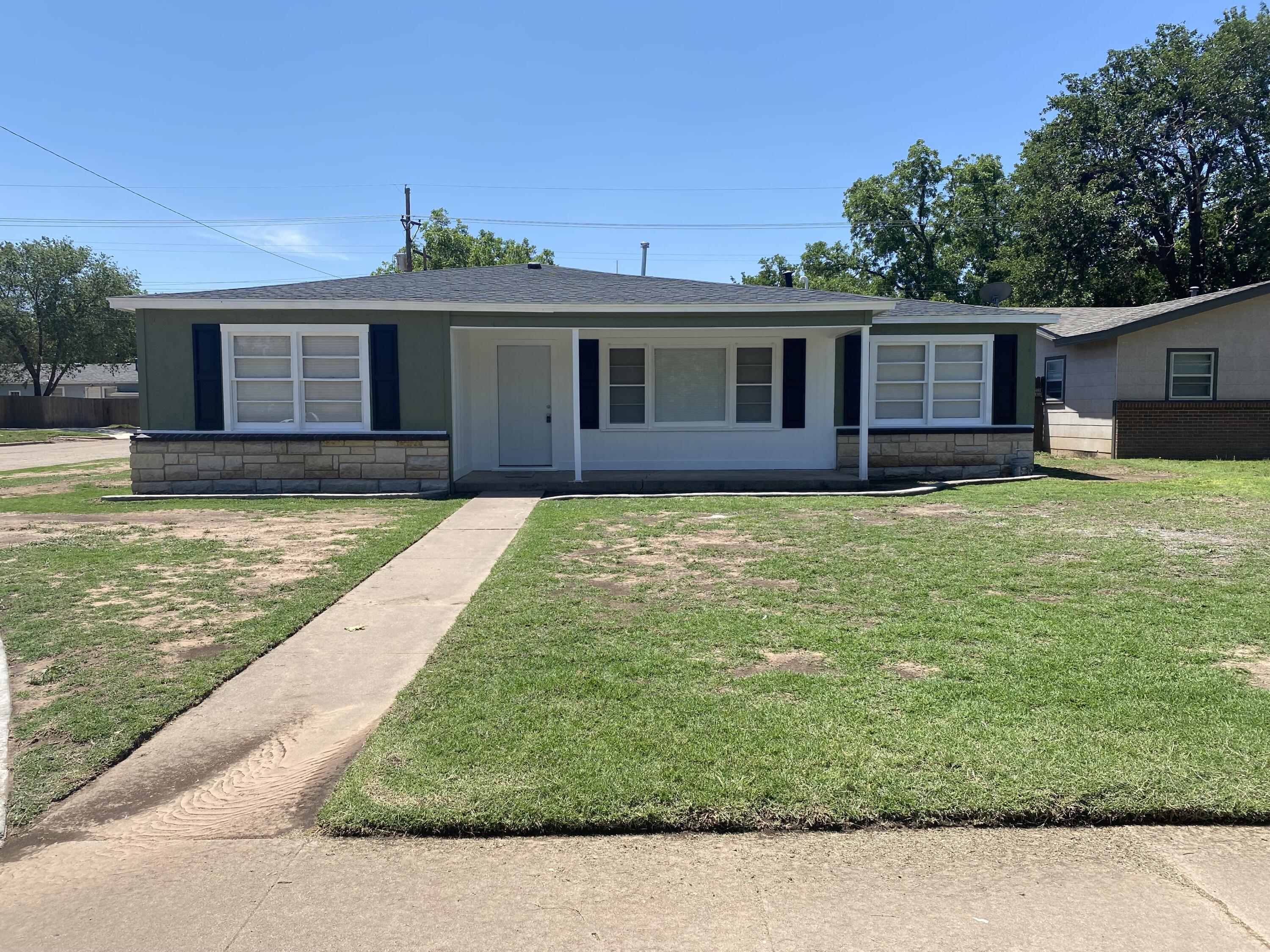 4101 32nd Street Lubbock, TX 79410 - Photo 3 of 13 a view of a yard with a house and a swimming pool
