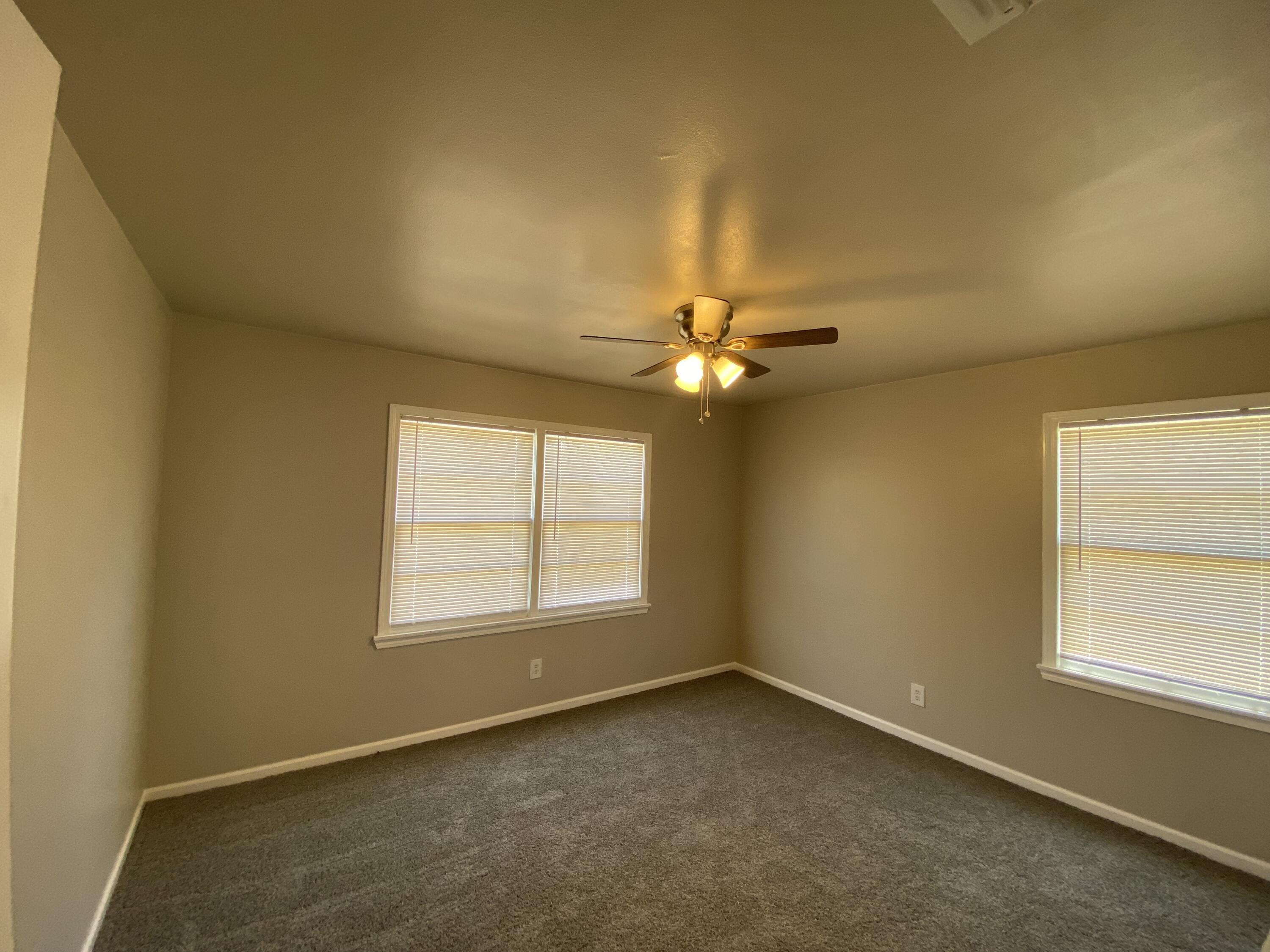4101 32nd Street Lubbock, TX 79410 - Photo 8 of 13 an empty room with windows and fan