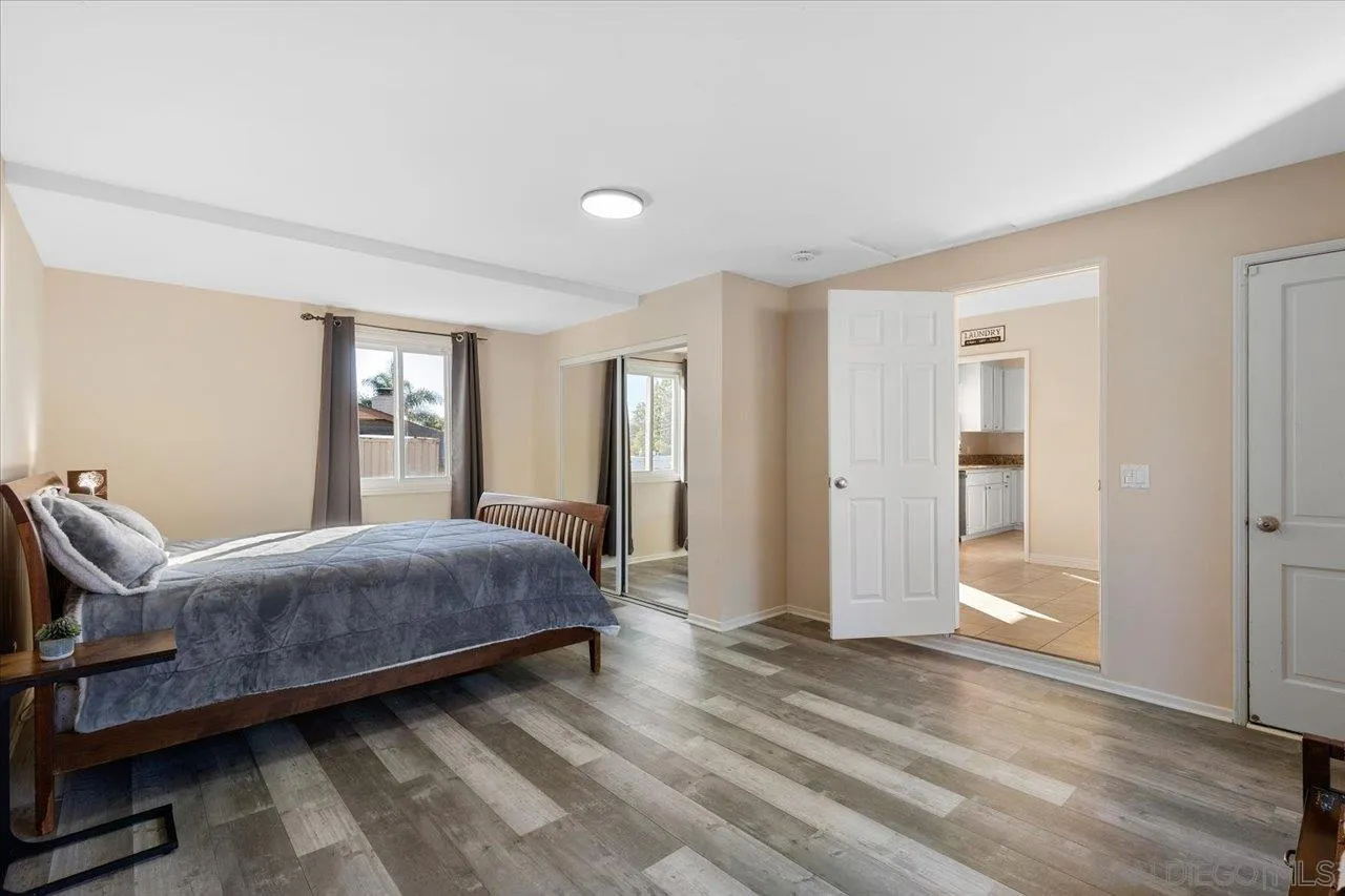 115 Ellis Lane Fallbrook, CA 92028 - Photo 18 of 36 a bedroom with a bed and glass door
