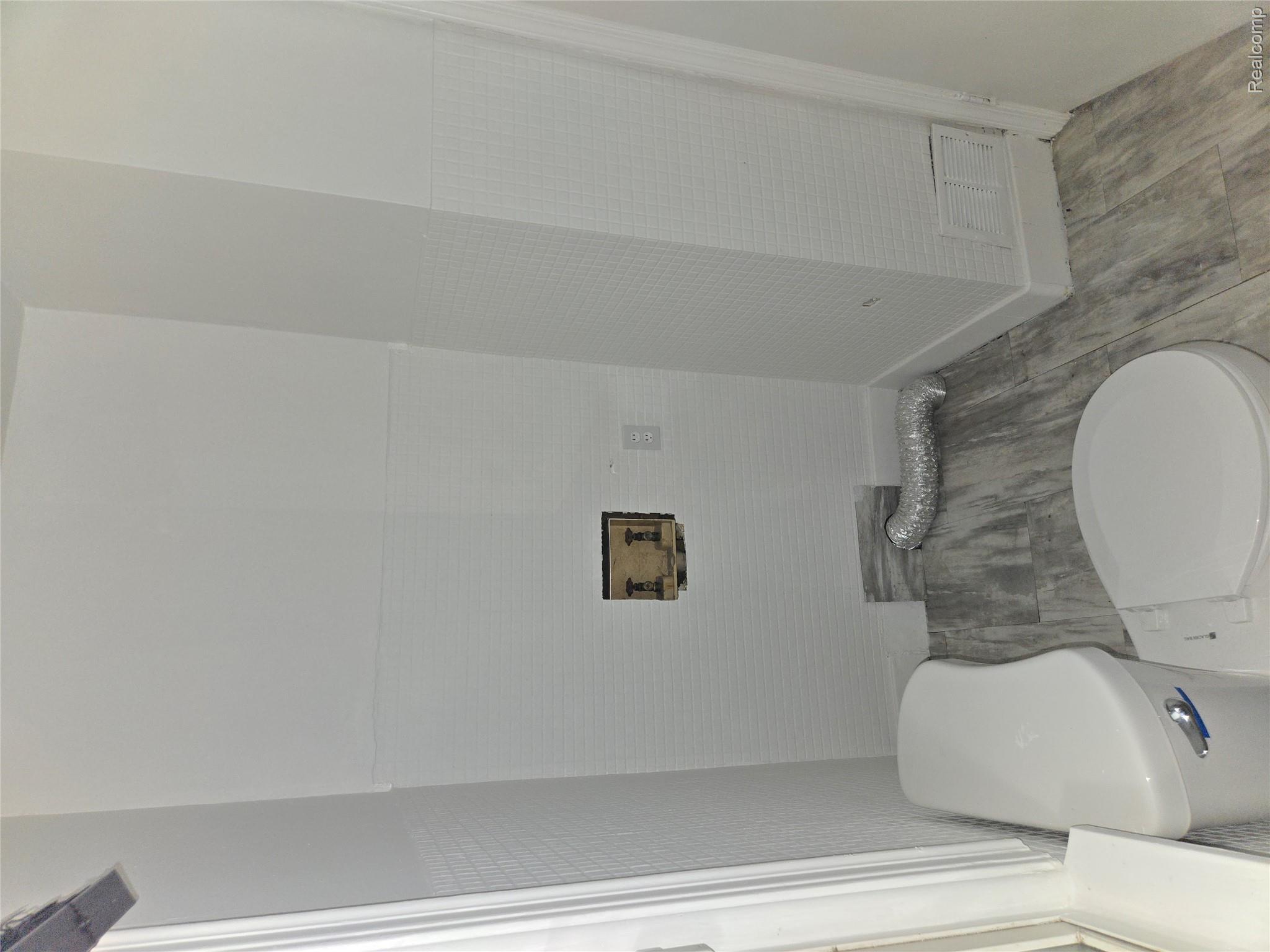 18119 Cornwall Street Detroit, MI 48224 - Photo 10 of 18 Bathroom featuring toilet and tile walls