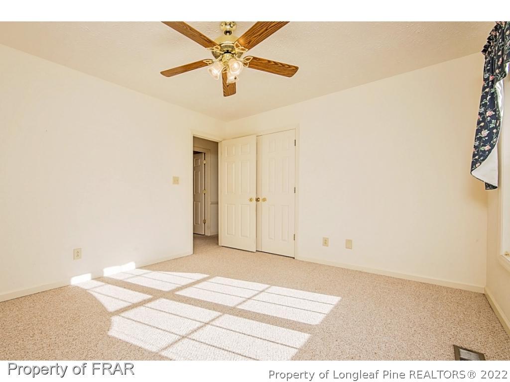 4615 Mobius Road Fayetteville, NC 28312 - Photo 26 of 36 an empty room with wooden floor and a ceiling fan
