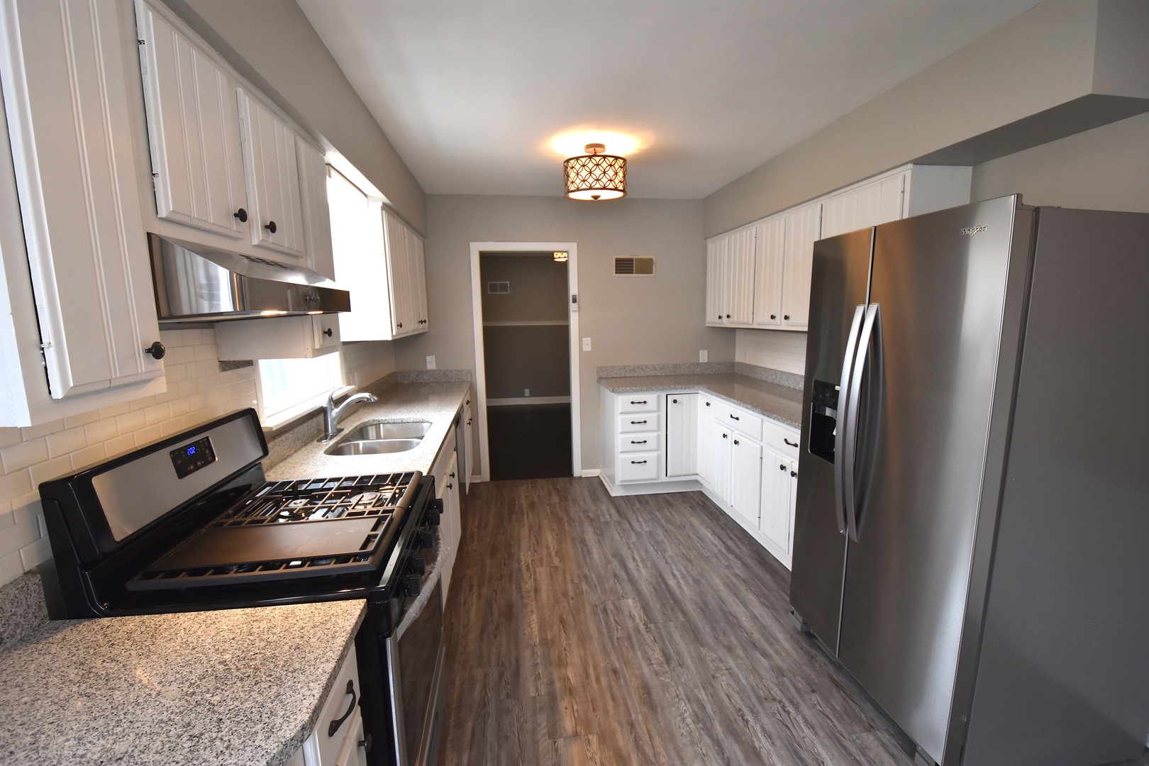 714 Normal Road DeKalb, IL 60115 - Photo 3 of 15 a kitchen with stainless steel appliances granite countertop a refrigerator stove top oven and sink