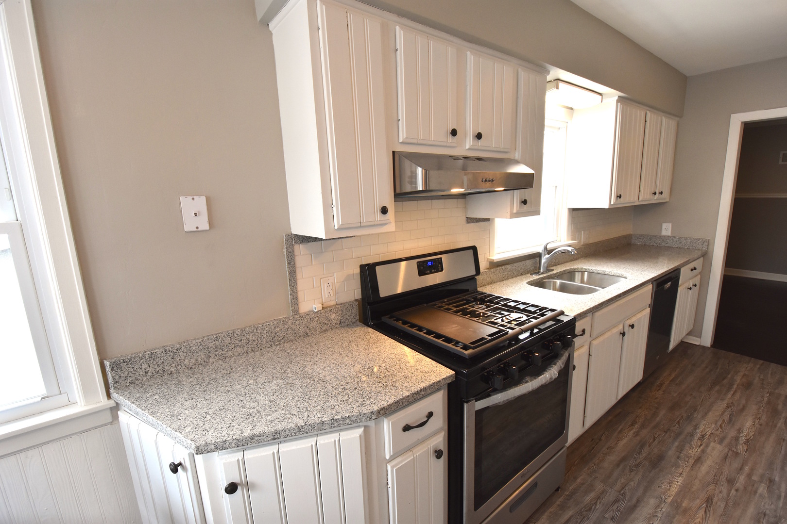 714 Normal Road DeKalb, IL 60115 - Photo 4 of 15 a kitchen with stainless steel appliances granite countertop a stove a sink and a white cabinets